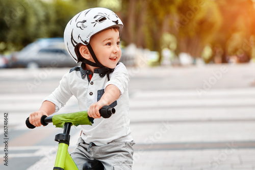 boy in a helmet riding bike