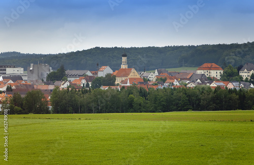 rural areas in Germany, Bavaria, with brightly green fields and trees small and.village .