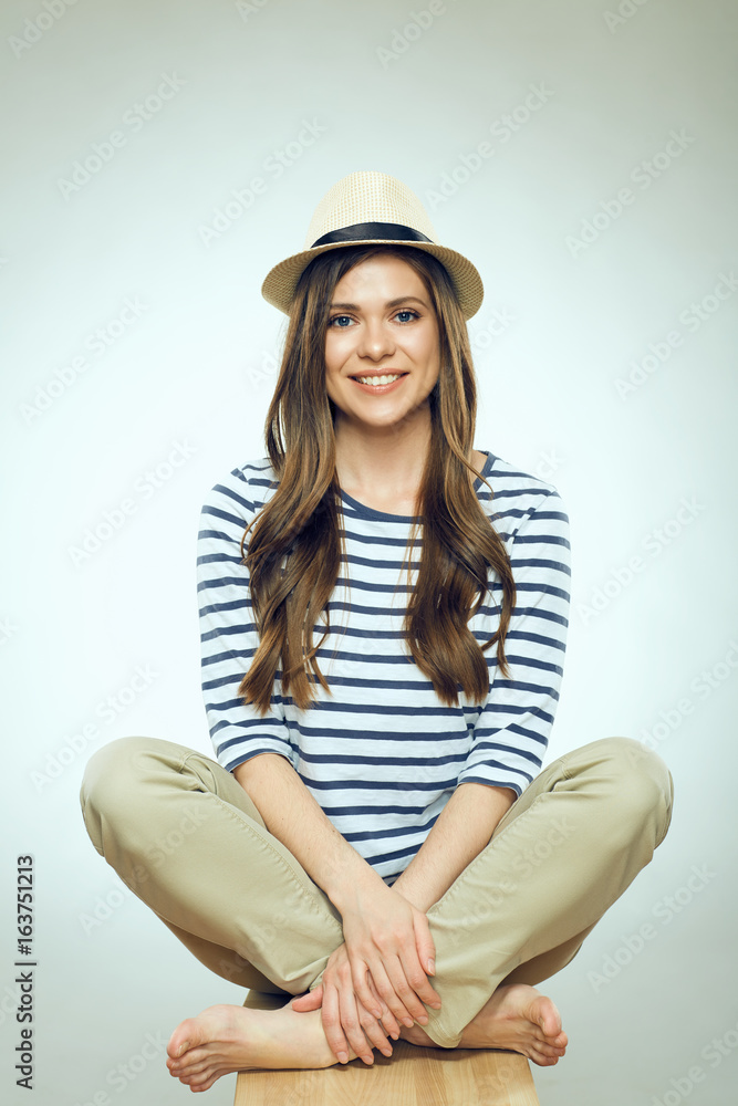 Portrait of smiling sitting woman wearing hat Portrait of smiling sitting woman wearing hat