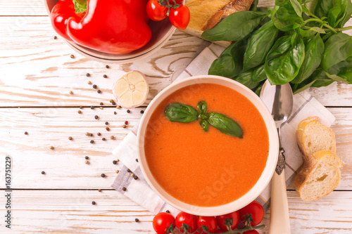 Italian tomato soup gazpacho with basil, tomatoes and baguette