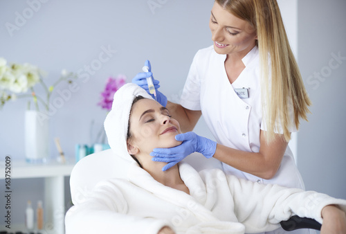 Woman receiving botox injection in clinic