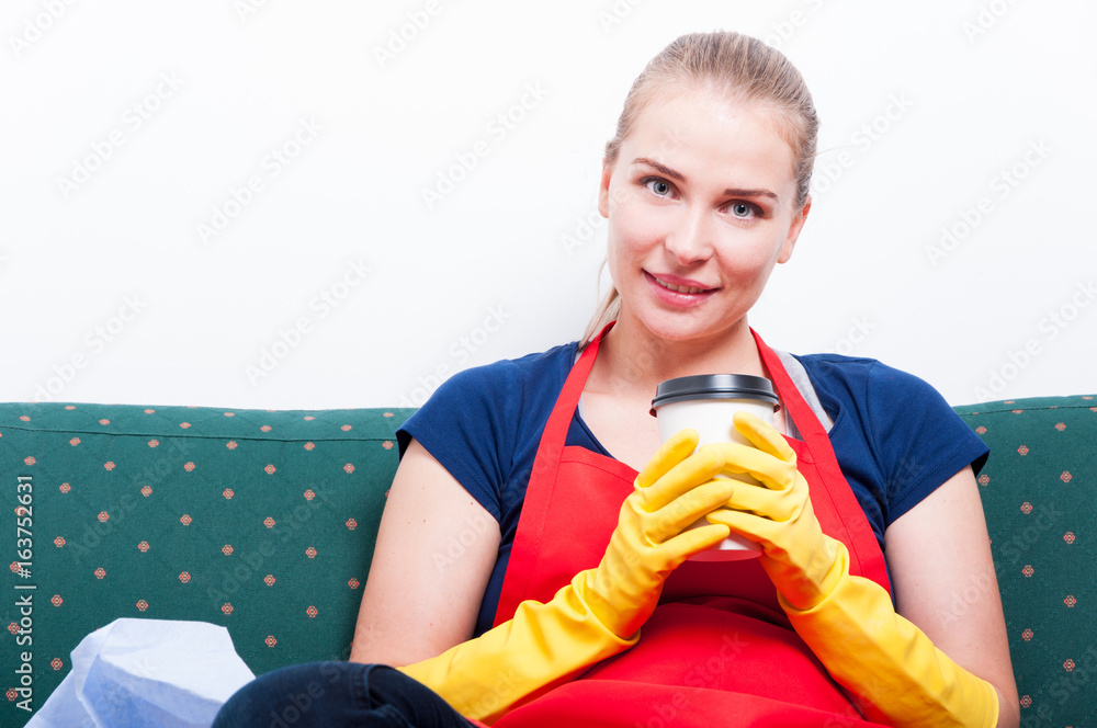 Female cleaner sitting and relaxing with fresh coffee Female cleaner sitting and relaxing with fresh coffee