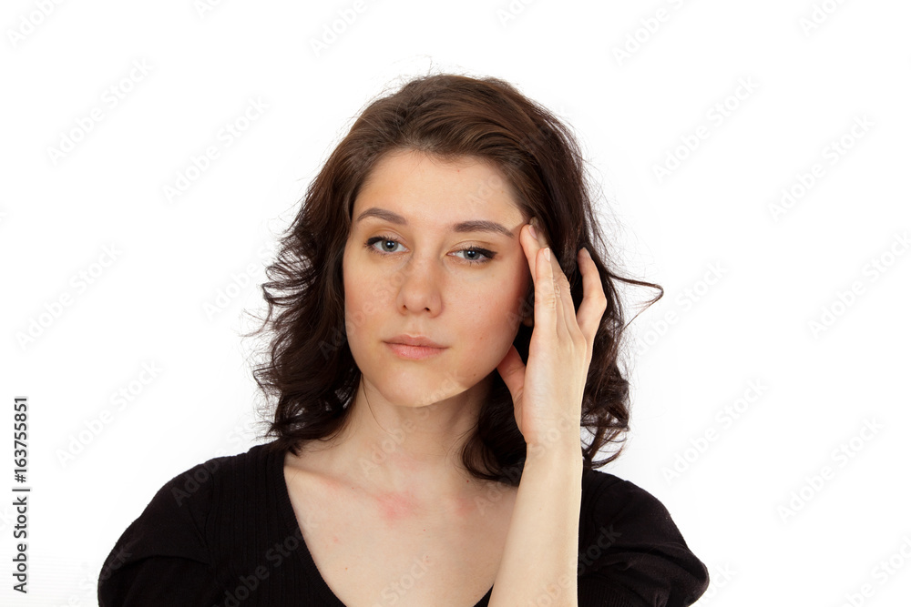 Young woman lost in thought put her hand to the face Young woman lost in thought put her hand to the face