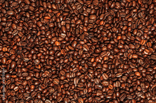 Dark many roasted coffee beans texture background