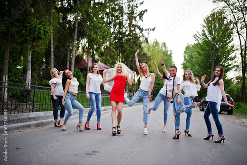Girls having fun while posing outside in the park on the bachelorette party.