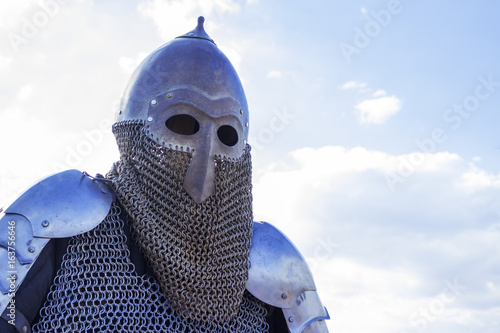 Modern copy of antique metal knight helmet with aventail. Historical medieval costume detail photo