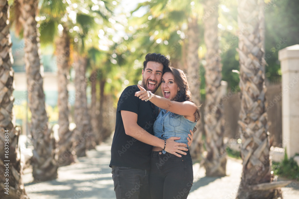 Fototapeta premium Happy couple standing together outside looking away
