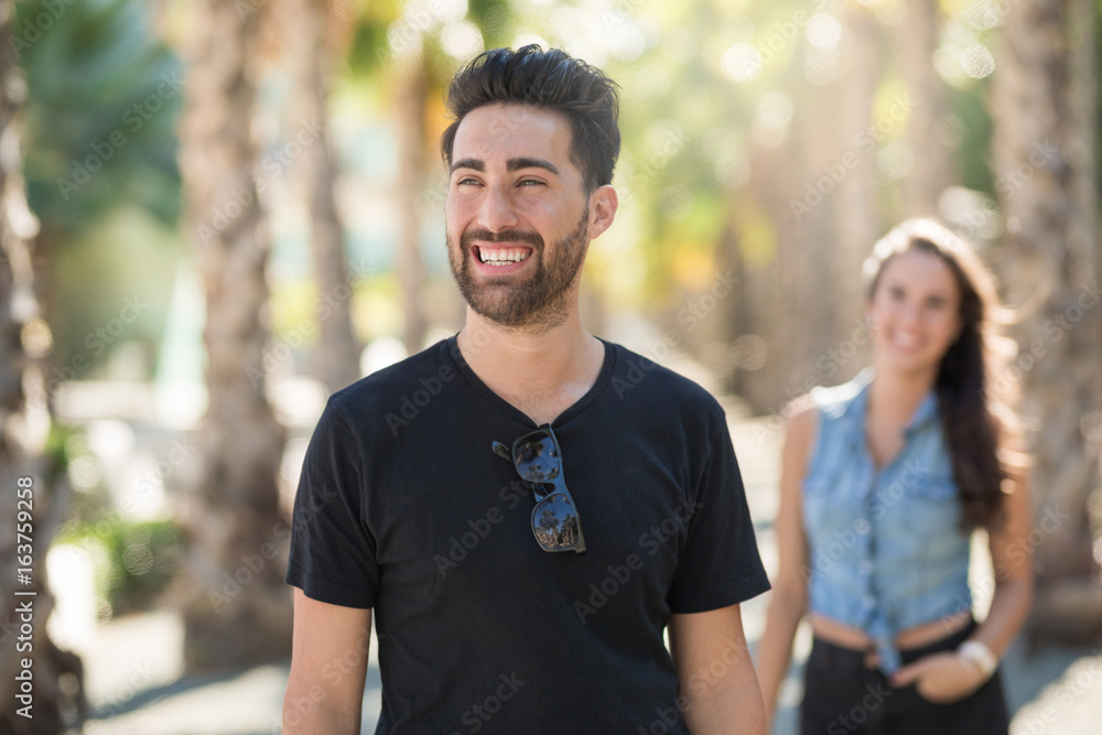 Happy young man on walk with girlfriend looking away Happy young man on walk with girlfriend looking away