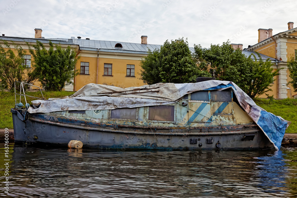 Old rusty machinery boat on the river dock. Old rusty machinery boat on the river dock.