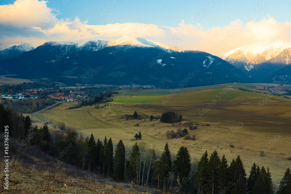 Foothills in Tatra Mountains, Slovakia, with snowy peaks.