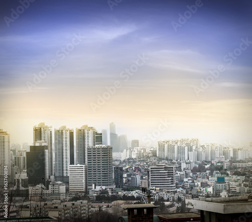 Seoul cityscapes sunset lighting effect, skyline, high rise office buildings and skyscrapers in Seoul city, winter daylight, top view in winter, Seoul, Republic of Korea, in mist © lukyeee_nuttawut