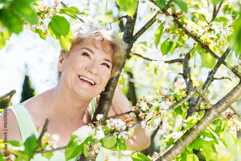 Attractive mature woman embracing nature. Grandmother Attractive mature woman embracing nature. Grandmother