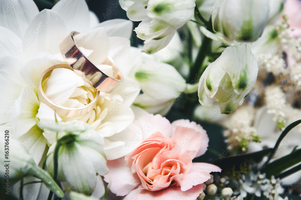 Wedding rings on decorative flowers background. Wedding rings on decorative flowers background.