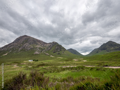 Buachaille Etive Mor, Scottish Highlands. A path leading past a crofters cottage into the Bidean Nam Bian mountains near Glencoe, Argyll, Scotland. © pxl.store