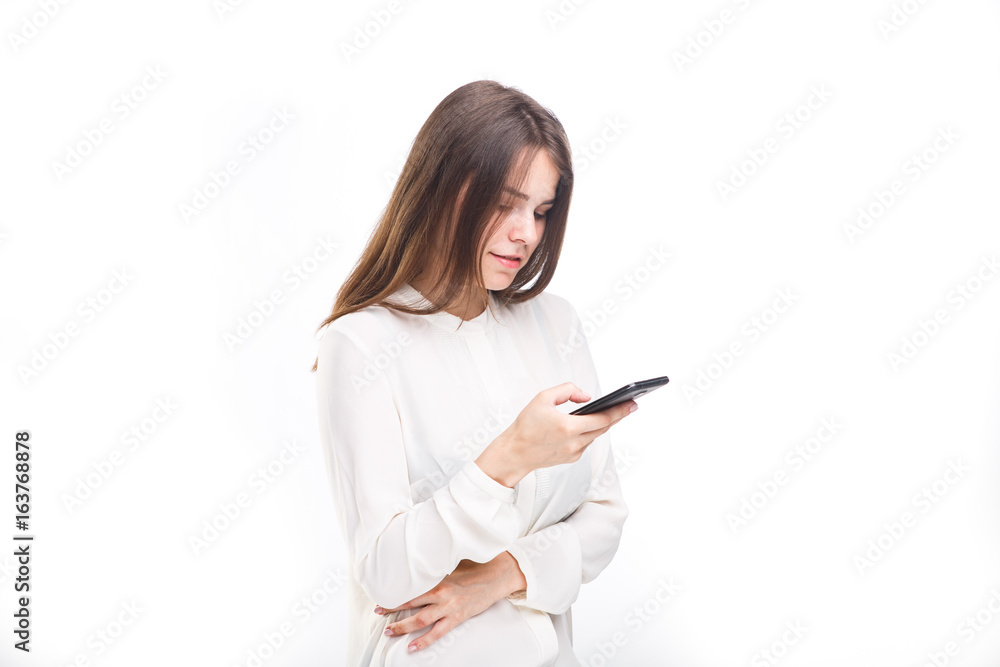 Portrait happy, smiling woman texting on her smart phone, isolated white background. Communication concept. Internet, phone addiction Portrait happy, smiling woman texting on her smart phone, isolated white background. Communication concept. Internet, phone addiction