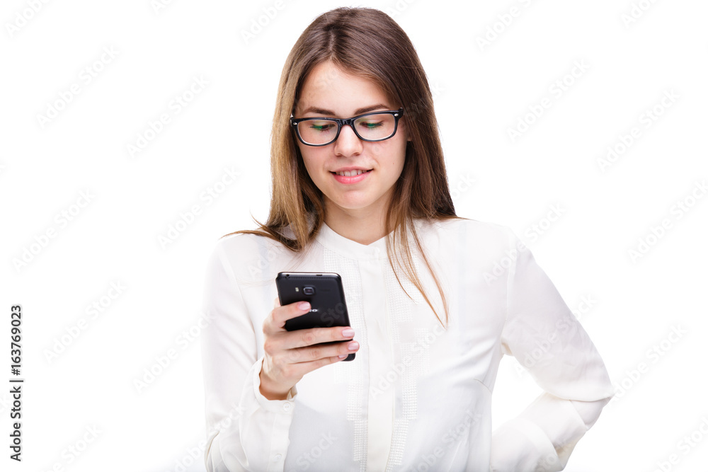 Portrait happy, smiling woman texting on her smart phone, isolated white background. Communication concept. Internet, phone addiction