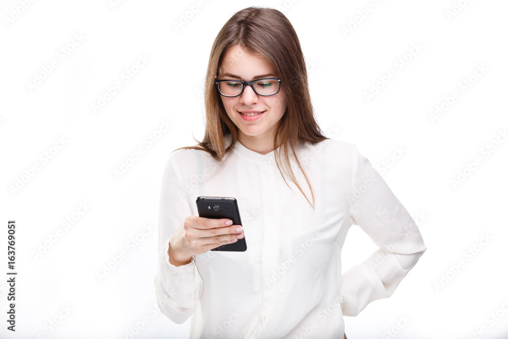 Portrait happy, smiling woman texting on her smart phone, isolated white background. Communication concept. Internet, phone addiction Portrait happy, smiling woman texting on her smart phone, isolated white background. Communication concept. Internet, phone addiction