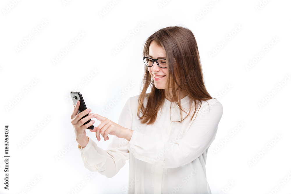 Portrait happy, smiling woman texting on her smart phone, isolated white background. Communication concept. Internet, phone addiction Portrait happy, smiling woman texting on her smart phone, isolated white background. Communication concept. Internet, phone addiction