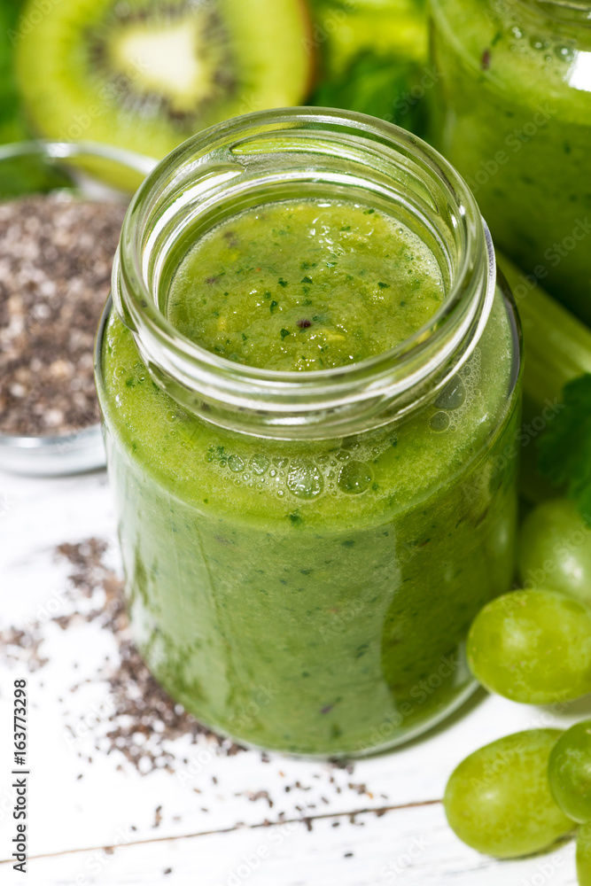 healthy green fruit and vegetable smoothies in jars on white background, closeup healthy green fruit and vegetable smoothies in jars on white background, closeup