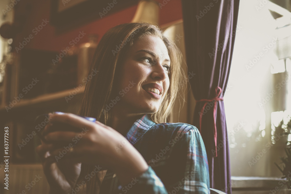 Fototapeta premium Beautiful woman enjoying in cup of coffee. Young man drinking coffee.