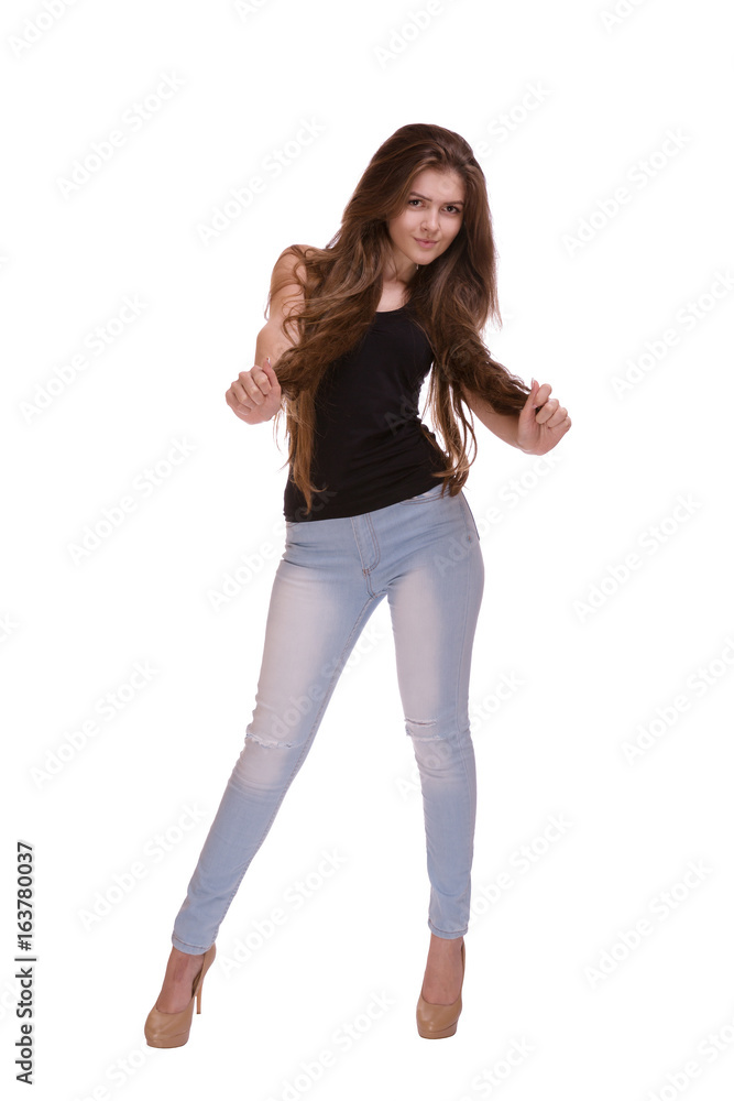 Fashionable model with chic hair in jeans. Beautiful teenage girl with long hair posing wearing trendy boho outfit. Fashionable model with chic hair in jeans. Beautiful teenage girl with long hair posing wearing trendy boho outfit.