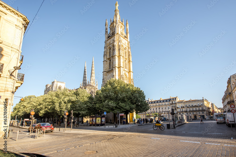 Naklejka premium Morning view on the square with saint Pierre cathedral tower in Bordeaux city, France