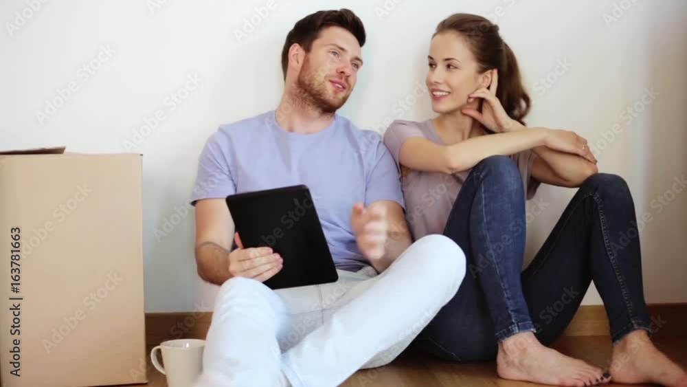 happy couple with tablet pc at new home happy couple with tablet pc at new home