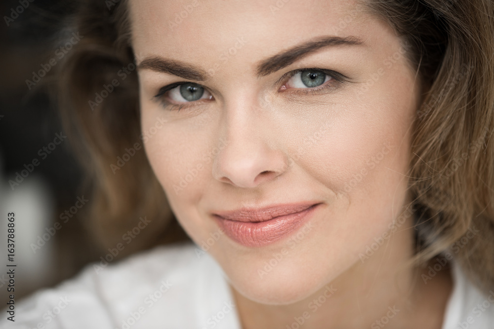portrait of attractive smiling blonde woman looking at camera portrait of attractive smiling blonde woman looking at camera