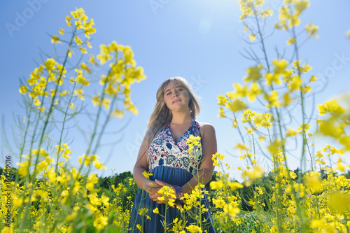 Cute woman in a yellow flowers field