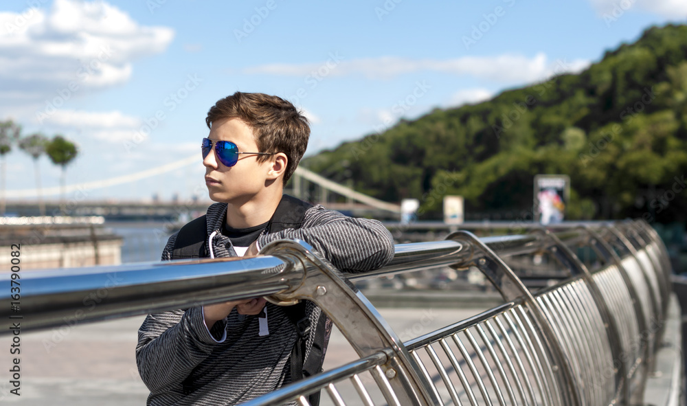 young man on a bridge in a big city