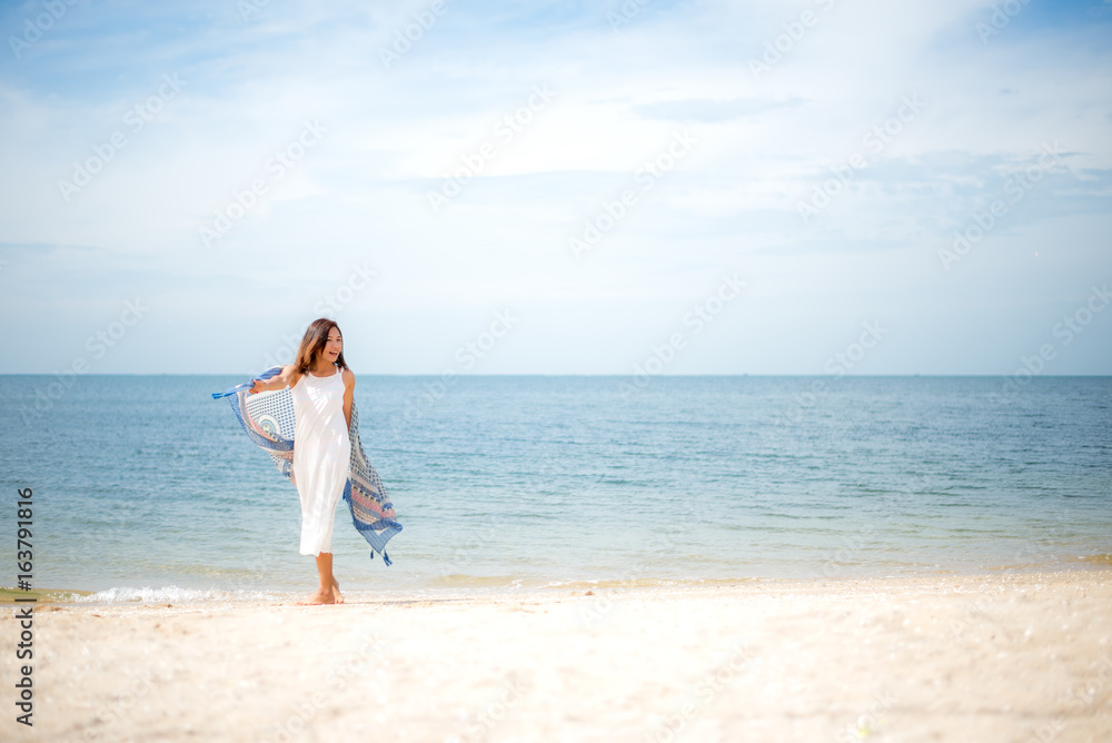 Young women jumping and happy on the beach. Travel and Vacation. Summer Concept Young women jumping and happy on the beach. Travel and Vacation. Summer Concept