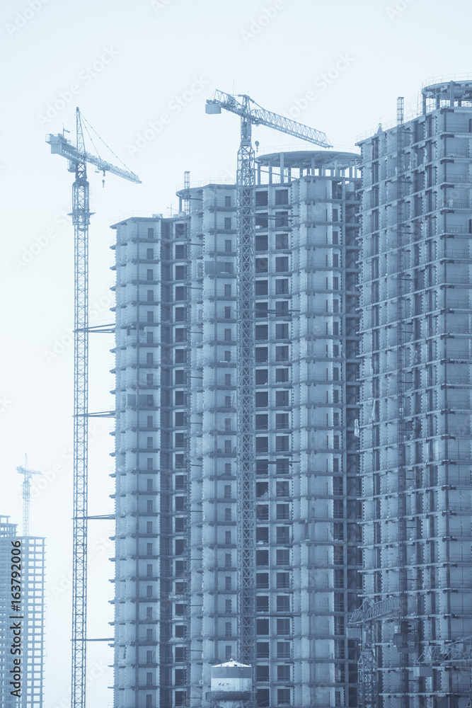 Cranes building a block Cranes building a block