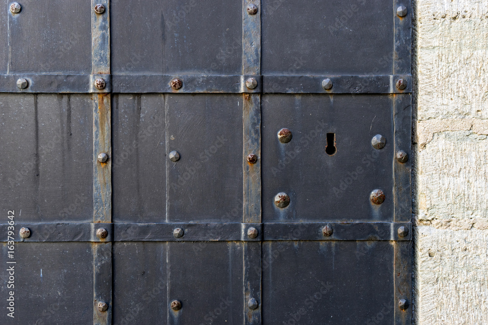 Iron painted door with keyhole, background with copy space for text.