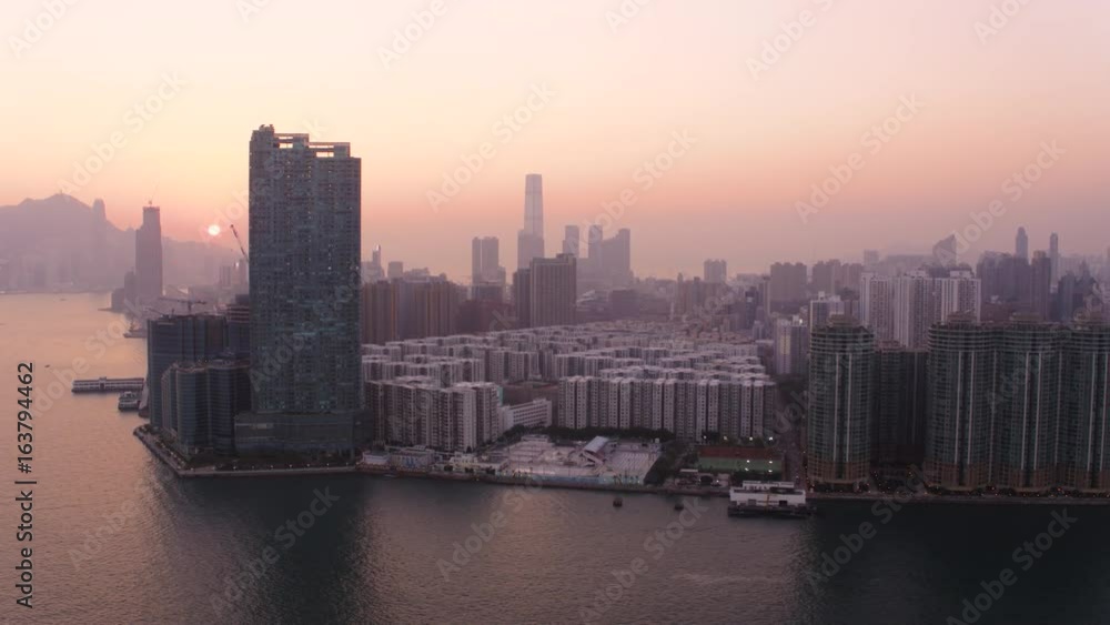 Hong Kong Aerial v121 Flying low over Kowloon Bay panning with cityscape sunset views Hong Kong Aerial v121 Flying low over Kowloon Bay panning with cityscape sunset views
