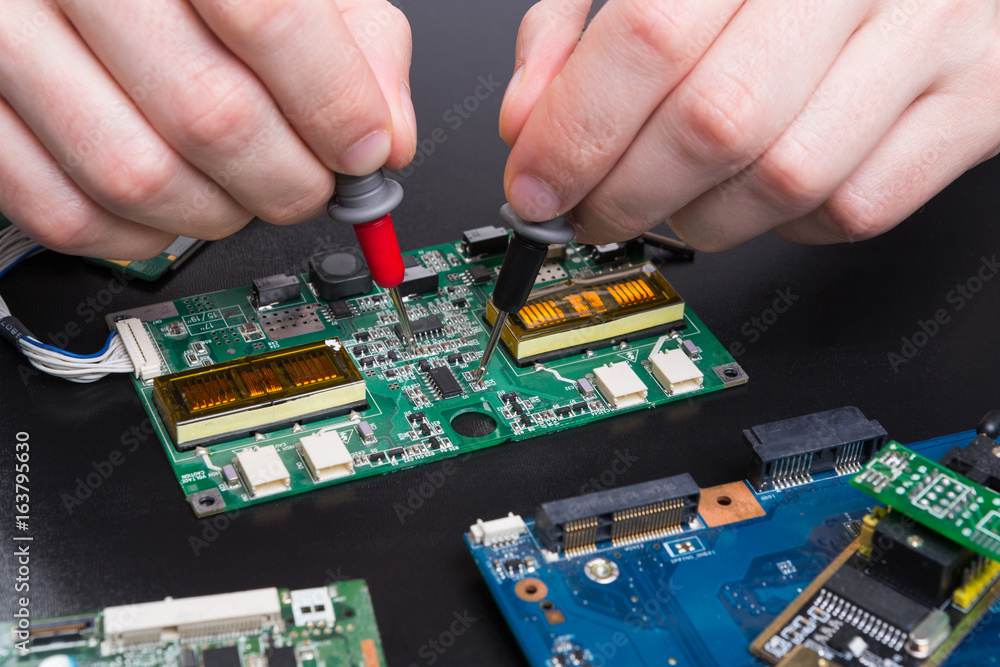 Electronic circuit board inspecting close up Electronic circuit board inspecting close up