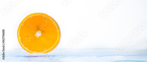 Oranges are falling in the water.