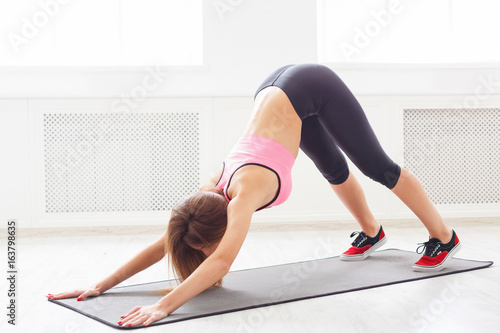 Yoga stretching. Woman in dog pose