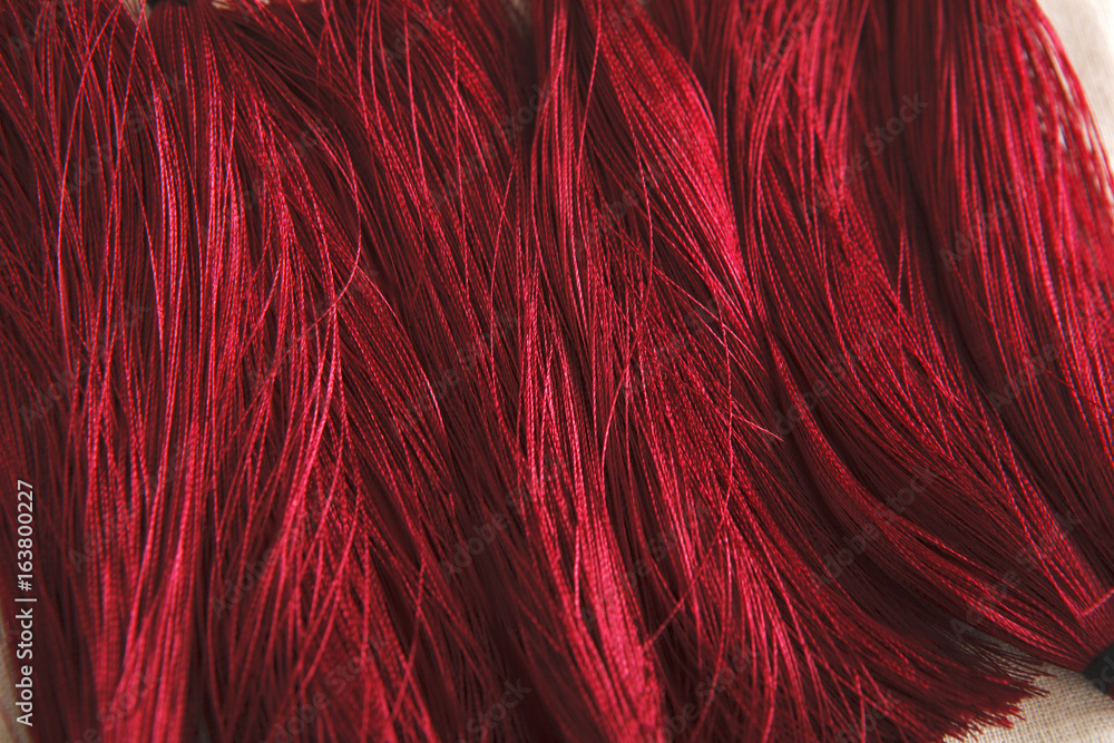 Fototapeta premium Red tassels background close up