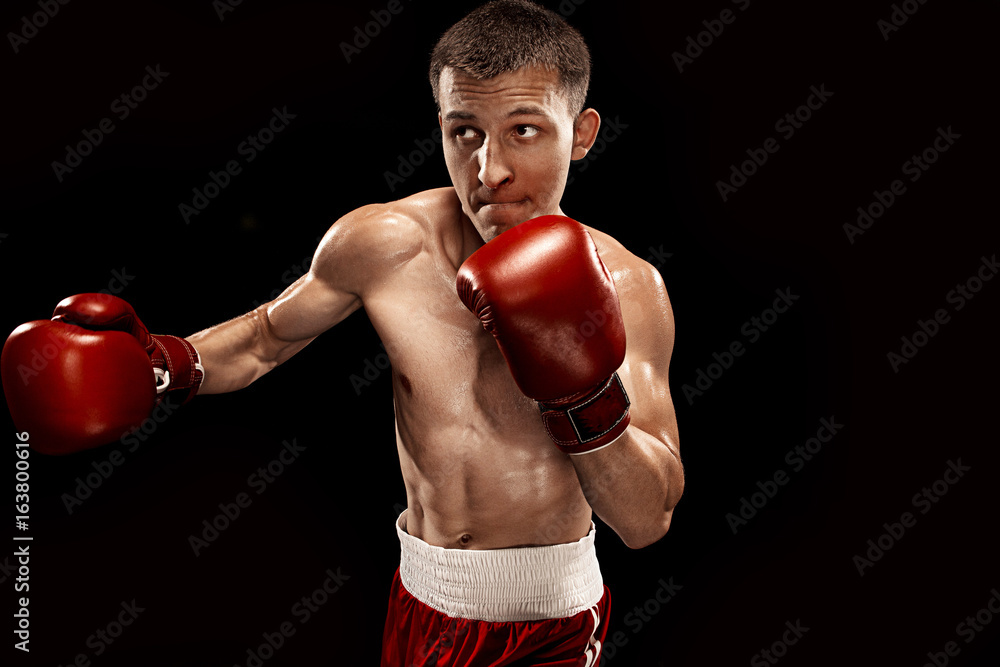 Male boxer boxing with dramatic edgy lighting in a dark studio