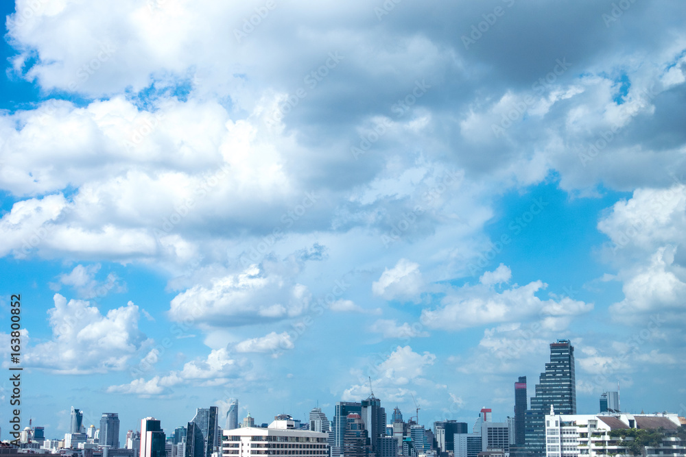 Sky & clouds background with city view at bottom part.