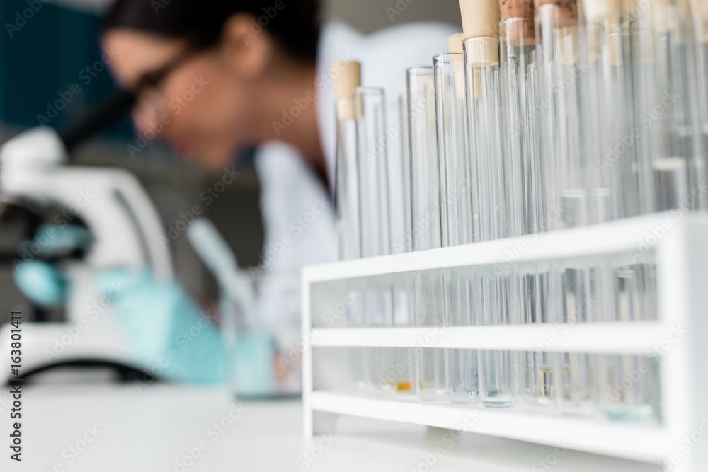 Close-up view of test tubes with reagents and samples on table in chemical lab Close-up view of test tubes with reagents and samples on table in chemical lab