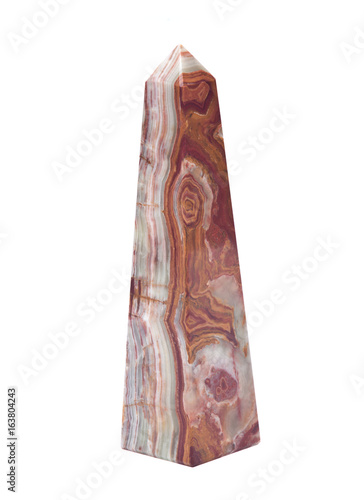 Polished multicolor carved onyx obelisk isolated on white background