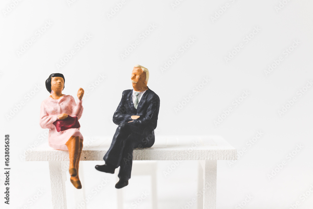 Miniature people business concept sitting on chair with a space for text