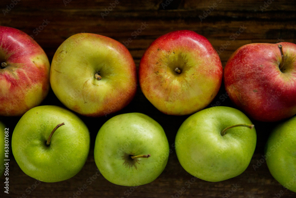 Fresh red apples with green leaves on wooden table. On wooden background. Free space for text . Top view Fresh red apples with green leaves on wooden table. On wooden background. Free space for text . Top view