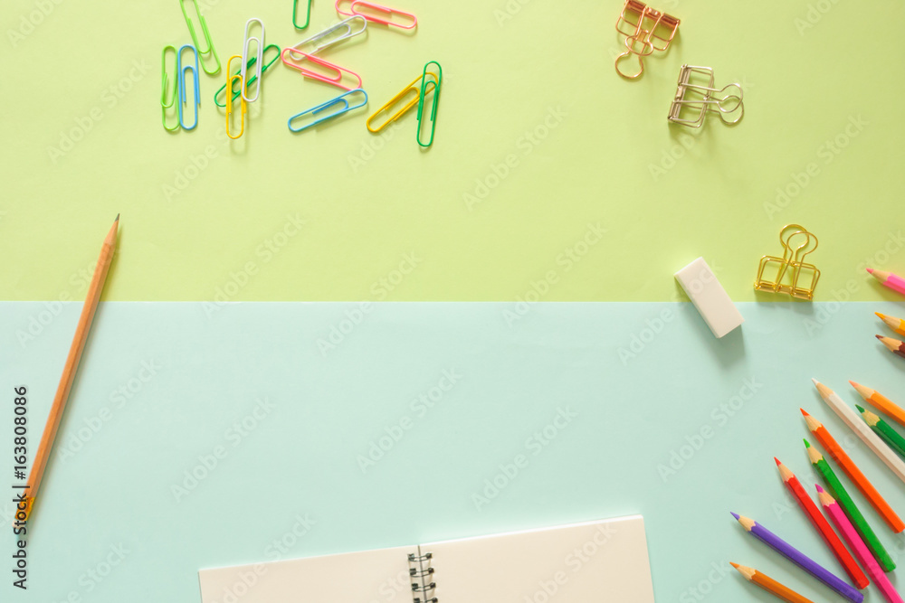 Minimal work space - Creative flat lay photo of workspace desk with sketchbook and wooden pencil on copy space green and blue pastel background. Top view , flat lay photography. Minimal work space - Creative flat lay photo of workspace desk with sketchbook and wooden pencil on copy space green and blue pastel background. Top view , flat lay photography.