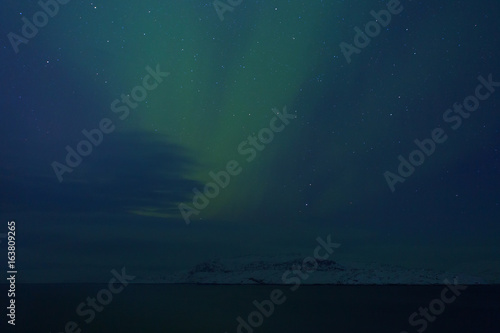 Aurora Borealis  Northern Lights  above coastal sea
