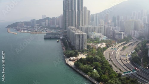 Hong Kong Aerial v137 Flying low around Quarry Bay waterfront panning with cityscape views photo