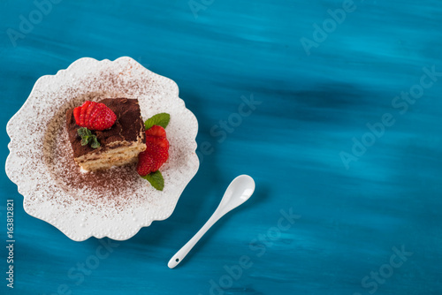 Strawberry tiramisu with mascarpone. Blue background top view photo