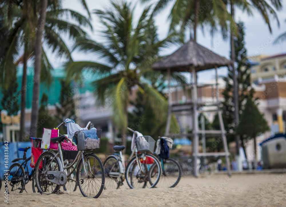 Fototapeta premium Bicycle on the beach on a blue sky