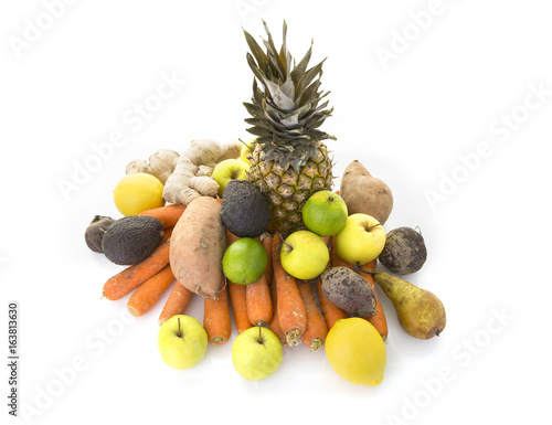 A pile of healthy fresh organic fruit and veg on a white background